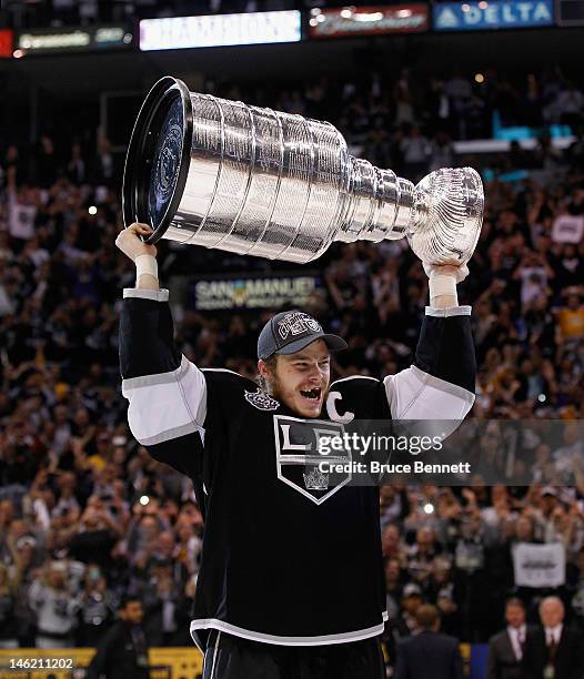 Dustin Brown of the Los Angeles Kings holds up the Stanley Cup after the Kings defeated the New Jersey Devils 6-1 to win the Stanley Cup series 4-2...