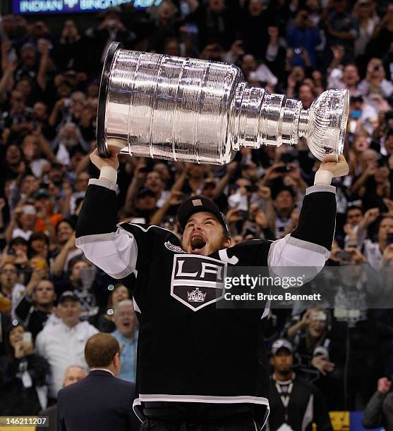 Dustin Brown of the Los Angeles Kings holds up the Stanley Cup after the Kings defeated the New Jersey Devils 6-1 to win the Stanley Cup series 4-2...