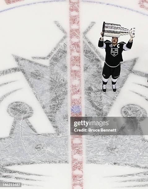 Dustin Brown of the Los Angeles Kings holds up the Stanley Cup after the Kings defeated the New Jersey Devils 6-1 to win the Stanley Cup series 4-2...