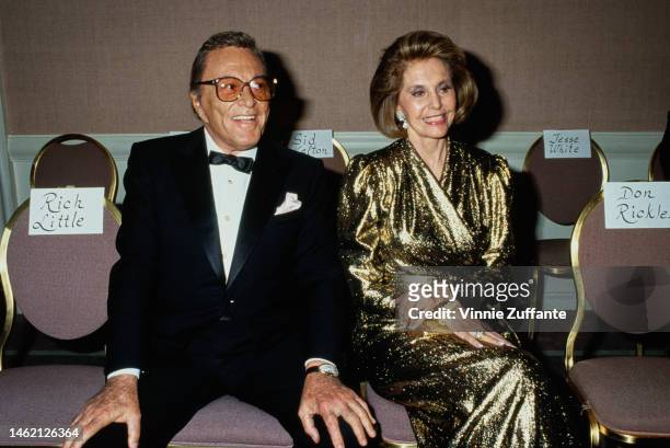 Danny Thomas and Cyd Charisse sit beside each other at an event, circa 1990s.
