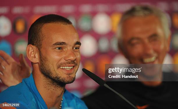 In this handout image provided by UEFA, Wesley Sneijder and coach Bert van Marwijk of Netherlands during a UEFA EURO 2012 press conference at the...