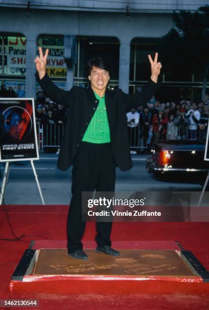 Jackie Chan embeds his hands and feet in Mann's Chinese Theatre cement. Hollywood, California, 5th January 1997.