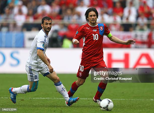 Tomas Rosicky of Czech Republic and Dimitris Salpigidis of Greece fight for the ball during the UEFA EURO 2012 group A match between Greece and Czech...