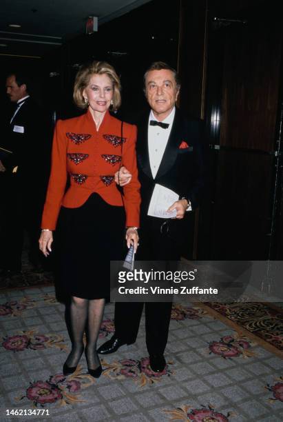 Cyd Charisse and Danny Thomas sit beside each other at an event, circa 1990s.