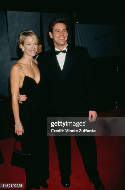 Jim Carrey and his partner, actress Lauren Holly, at the 1996 Fire and Ice Ball at the Warner Brothers Studios in Hollywood, California, 7th...