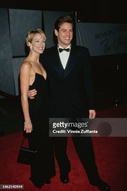 Jim Carrey and his partner, actress Lauren Holly, at the 1996 Fire and Ice Ball at the Warner Brothers Studios in Hollywood, California, 7th...