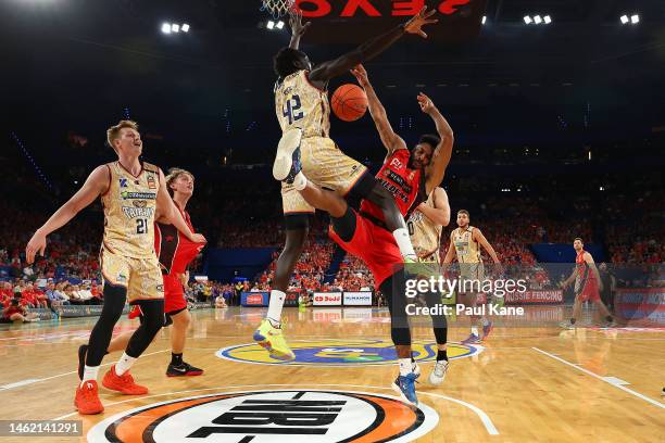 Corey Webster of the Wildcats gets blocked by Bul Kuol of the Taipans during the round 18 NBL match between Perth Wildcats and Cairns Taipans at RAC...