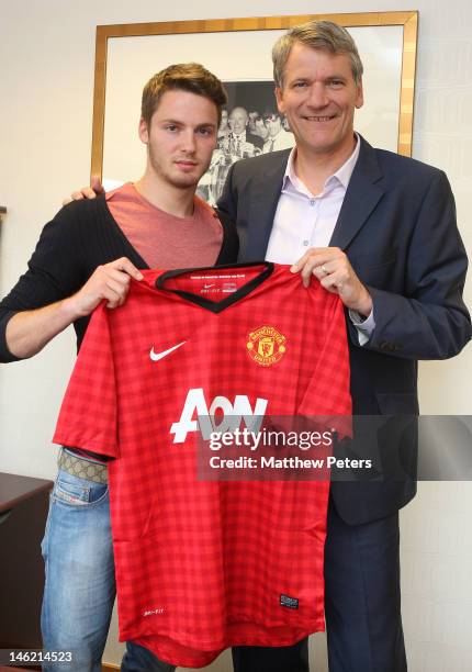 Manchester United's new signing Nick Powell from Crewe Alexandra poses with Manchester United's Chief Executive David Gill at Old Trafford on June...