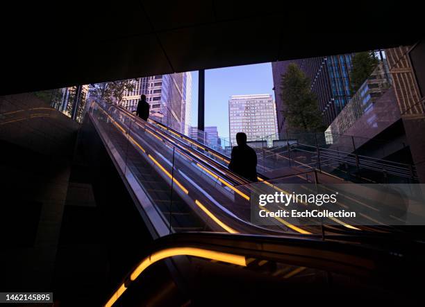 morning commuters arriving at marunouchi business district in tokyo, japan - tokyo financial building stock pictures, royalty-free photos & images
