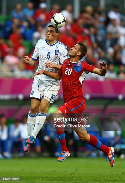 Kyriakos Papadopoulos of Greece and Tomas Pekhart of Czech Republic compete for the ball during the UEFA EURO 2012 group A match between Greece and...