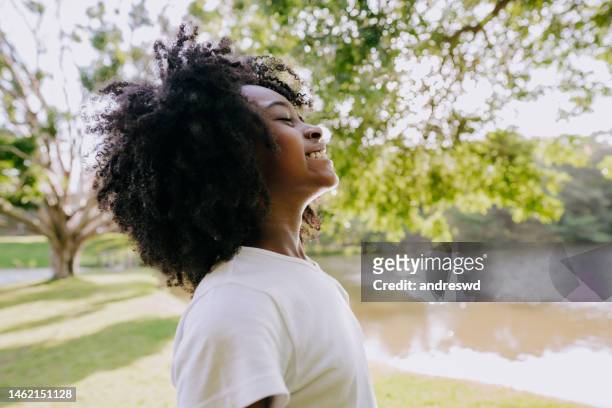 a child breathing clean air in nature smiling - bottomless girl stock pictures, royalty-free photos & images