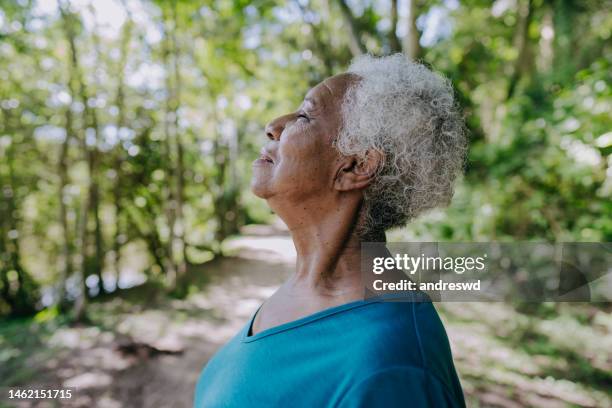 portrait of a senior woman breathing fresh air - andas in bildbanksfoton och bilder