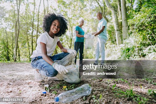 Girl collecting garbage from nature Girl collecting garbage from nature