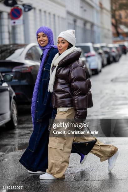 Fia Hamelijnck wears purple scarf, oversized dark blue denim jacket and jeans with slit, purple white sneakers Copenhagen Studios & Amaka Hamelijnck...