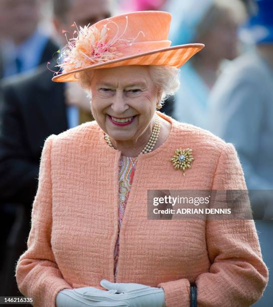 Britain's Queen Elizabeth II greets guests during a garden party in honour of her diamond jubilee at the Queen's Sandringham Estate in Norfolk on...