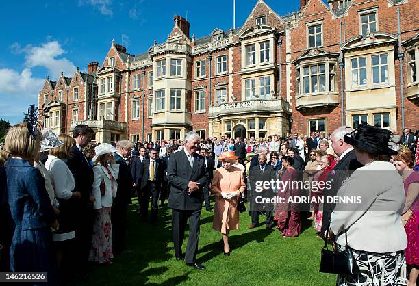 Britain's Queen Elizabeth II greets guests during a garden party in honour of her diamond jubilee at the Queen's Sandringham Estate in Norfolk on...
