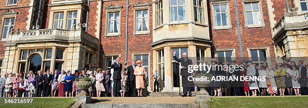 Britain's Queen Elizabeth II receives a round of applause from guests to conclude a garden party in honour of her diamond jubilee at the Queen's...