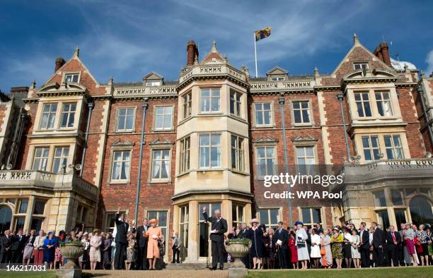 Prince Andrew, Duke of York looks on whilst Queen Elizabeth II receives a round of applause from guests to conclude a garden party in honour of her...