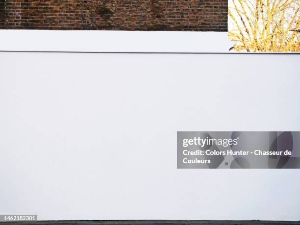 white concrete and old bricks walls with pavement and sunny trees in london - paint branch stock pictures, royalty-free photos & images