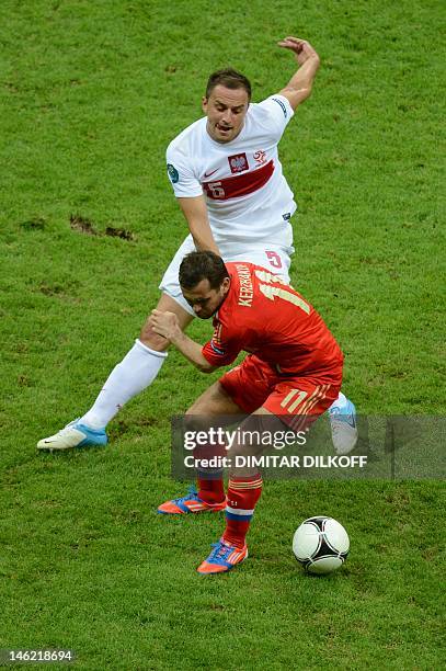 Polish midfielder Dariusz Dudka vies with Russian forward Aleksander Kerzhakov during the Euro 2012 championships football match Poland vs Russia on...