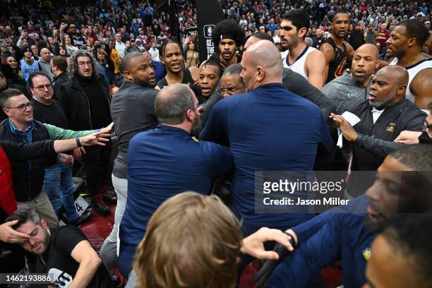 Head coach Taylor Jenkins tries to help break up a fight between Dillon Brooks of the Memphis Grizzlies and Donovan Mitchell of the Cleveland...
