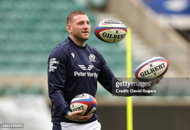 Finn Russell juggles rugby balls during the Scotland captain's run at Twickenham Stadium on February 03, 2023 in London, England.