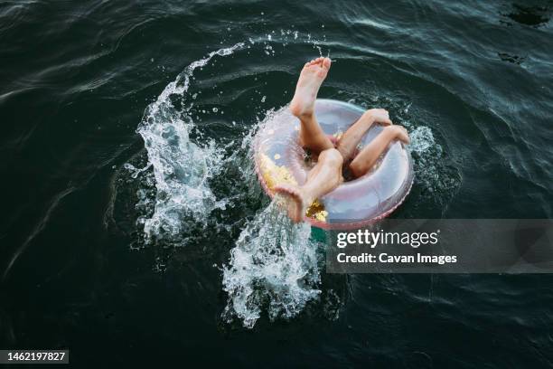 kid's limbs sticking out of swim float in lake - missouri lake stock pictures, royalty-free photos & images