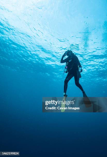 diver ascending to the surface in the south andaman sea - diving flippers stock pictures, royalty-free photos & images