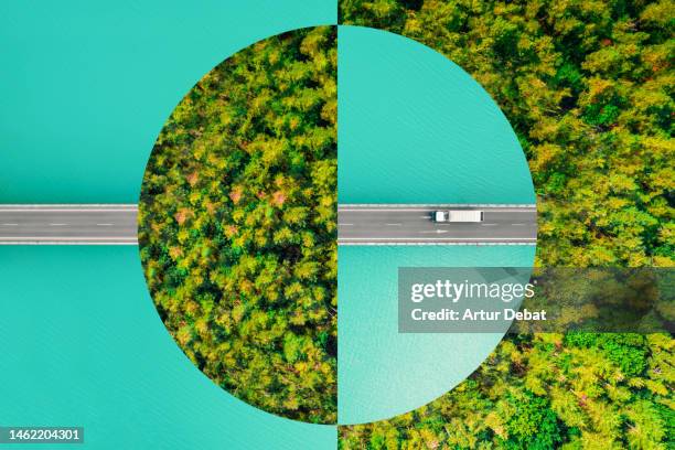 creative picture montage with a circle shape, connecting an elevated road with a green forest, evoking sustainable development and fair use of planetary resources. - movilidad sostenible fotografías e imágenes de stock