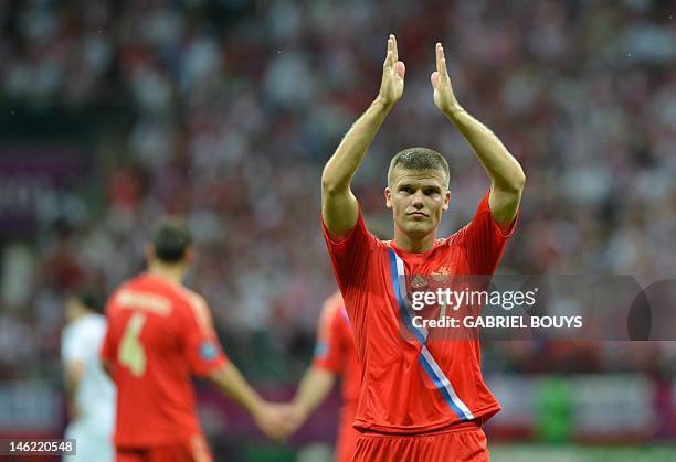 Russian midfielder Igor Denisov applauds his team's supporters at the end of the Euro 2012 championships football match Poland vs Russia on June 12,...