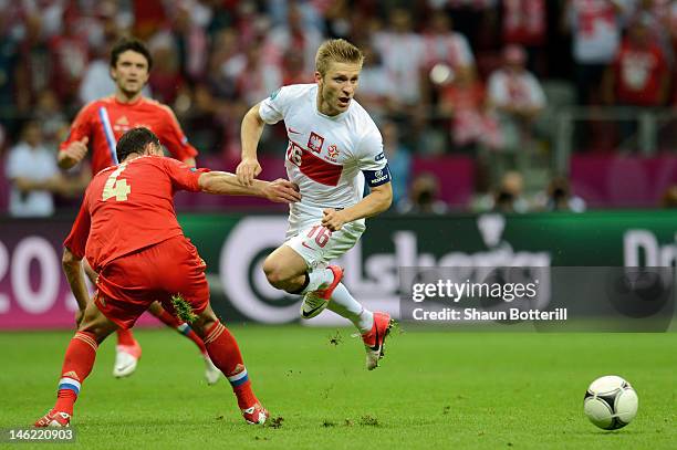 Jakub Blaszczykowski of Poland evades Sergey Ignashevich of Russia during the UEFA EURO 2012 group A match between Poland and Russia at The National...