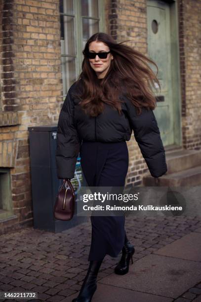 Annabel Rosendahl wearing a grey puffer jacket, navy skirt, and burgundy bag outside Mark Kenly Domino Tan during the Copenhagen Fashion Week...