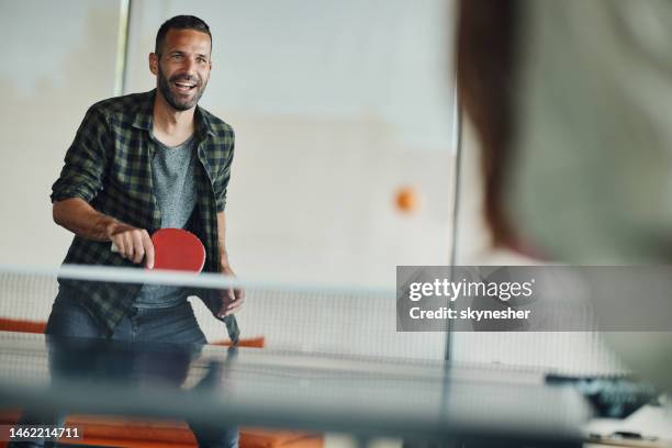 happy man enjoying while playing table tennis. - table tennis stock pictures, royalty-free photos & images