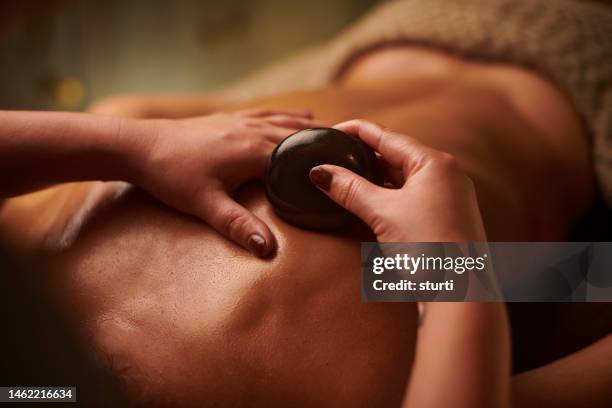 lastone massage - spa treatment stock pictures, royalty-free photos & images