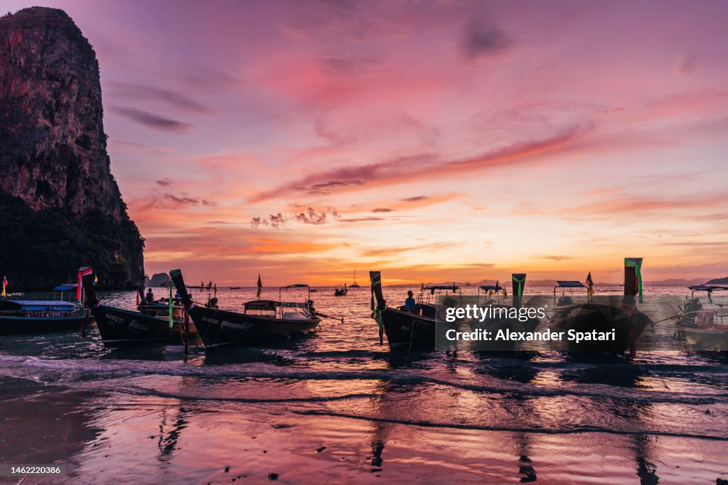 Railay Beach and longtail boats at sunset, Krabi, Thailand