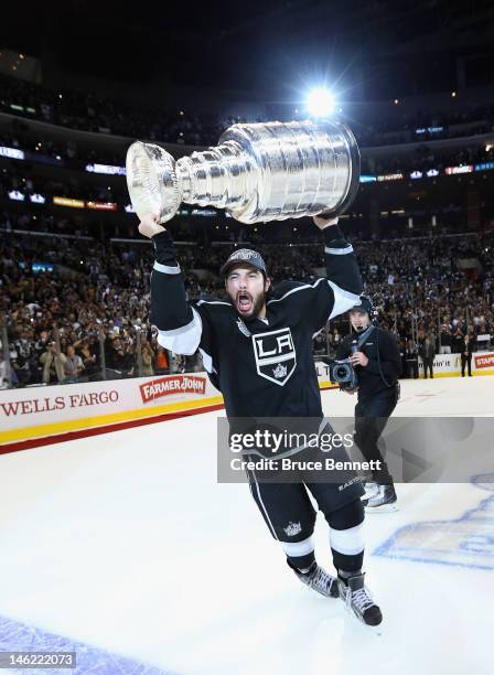 Drew Doughty of the Los Angeles Kings holds up the Stanley Cup after the Kings defeated the New Jersey Devils 6-1 to win the Stanley Cup series 4-2...