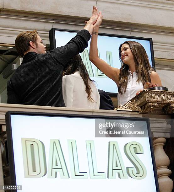 The Cast Of The New Series "Dallas", actors Josh Henderson and Julie Gonzalo "hi-five" during a visit to The New York Stock Exchange at the New York...