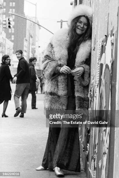 Blues singer Janis Joplin poses for a portrait on March 3, 1969 outside of the entrance to the Chelsea Hotel in New York City, New York.