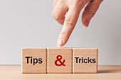 Tips and Tricks concept. written on wooden blocks, tips and tricks to help you in business