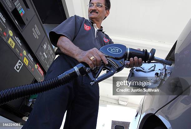 Worker pumps gasoline into a car on June 12, 2012 in San Anselmo, California. According to the Energy Department's weekly fuel survey, the average...
