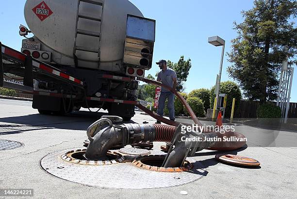 Gasoline truck driver Bhupinder Singh makes a gasoline delivery to a gas station on June 12, 2012 in San Anselmo, California. According to the Energy...