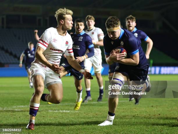 Harris McLeod of Scotland goes over to score their side's first try whilst under pressure from Sam Harris of England during the U20 Six Nations Rugby...