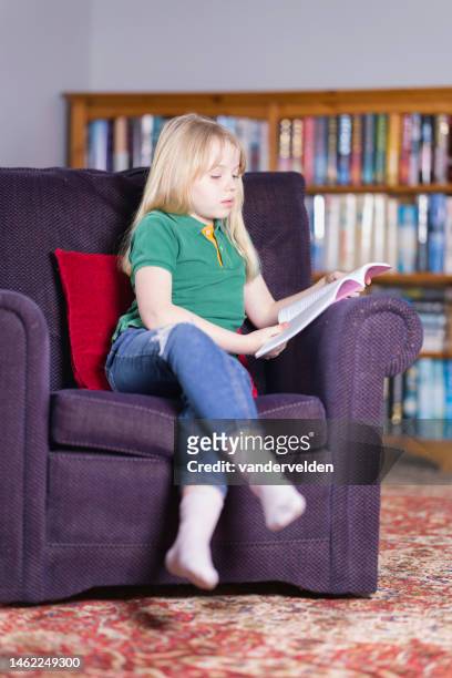 ten year old relaxing with a book - curled up reading book stock pictures, royalty-free photos & images
