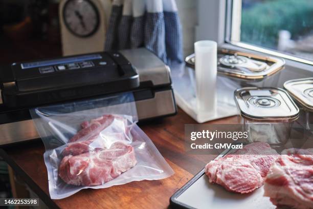 food safety - preserving fresh pork chops in a plastic bag with a vacuume sealer - vacuum packed bildbanksfoton och bilder