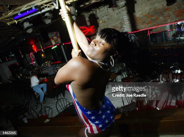 Monica, an exotic dancer, performs in a bar on Bourbon Street October 5, 2002 in the French Quarter of New Orleans, Louisiana. With Its exquisite...