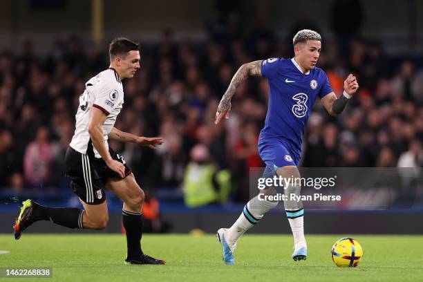 Enzo Fernandez of Chelsea runs with the ball whilst under pressure from Joao Palhinha of Fulham during the Premier League match between Chelsea FC...