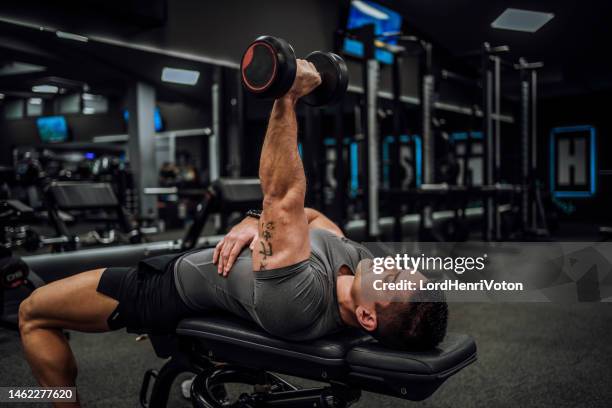 man exercising with dumbbells - bench dedication stock pictures, royalty-free photos & images