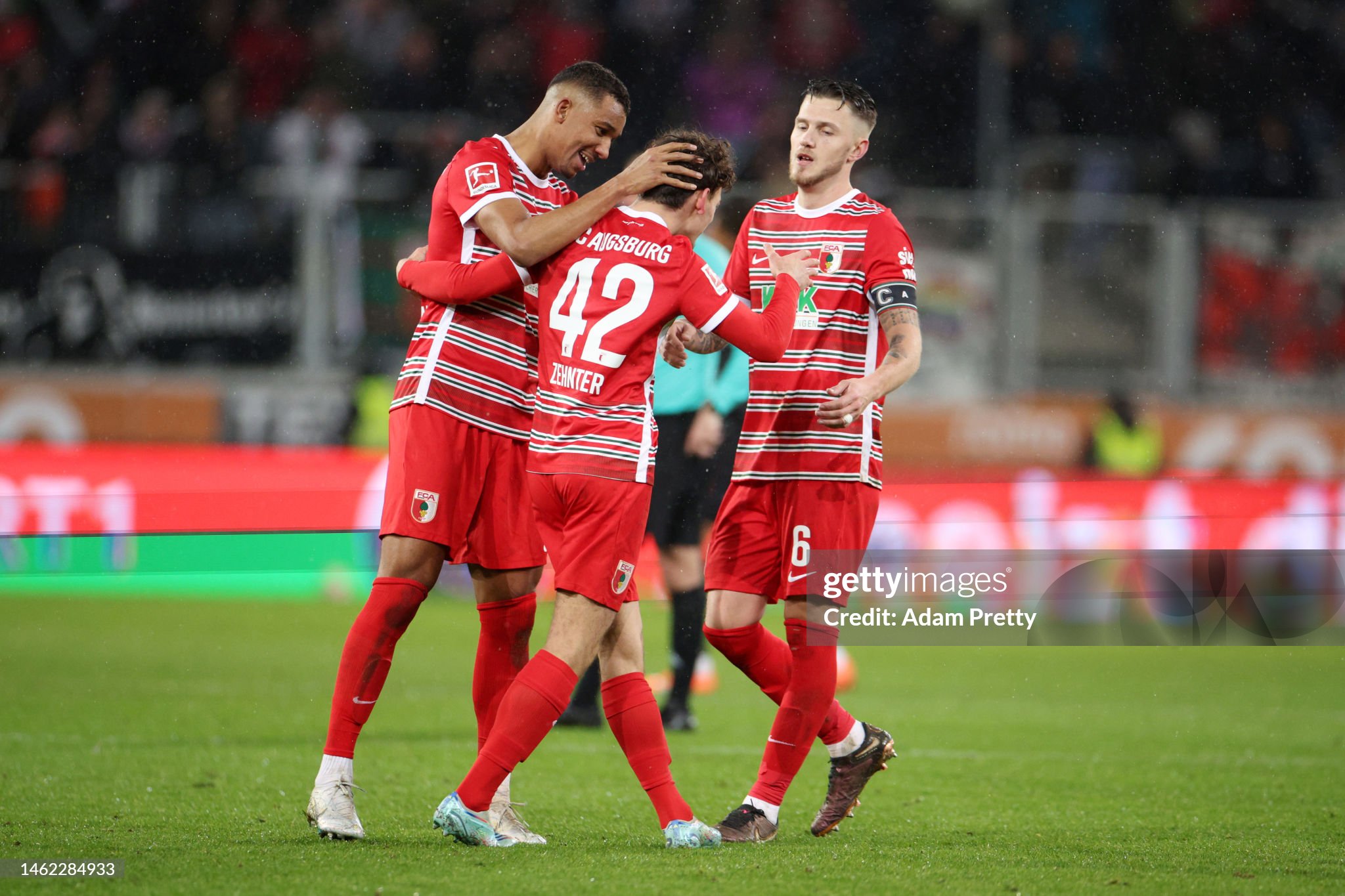AUGSBURG, GERMANY - FEBRUARY 03: Felix Uduokhai, Aaron Zehnter and Jeffrey Gouweleeuw of FC Augsburg celebrate their side's victory in the Bundesliga match between FC Augsburg and Bayer 04 Leverkusen at WWK-Arena on February 03, 2023 in Augsburg, Germany. (Photo by Adam Pretty/Getty Images)