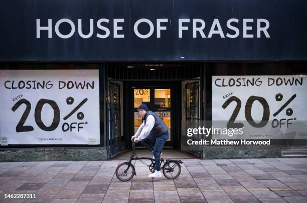 Man cycles past a House of Fraser store that is due to close on February 3, 2023 in Cardiff, Wales. The amount spent on retail in the UK dropped by...