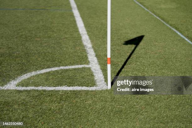 low angle view of the shadow of a corner kick flag on a soccer field with painted lines - corner kick - fotografias e filmes do acervo